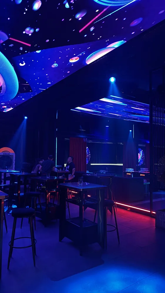 Blue-lit seating and tables at Babylon Club