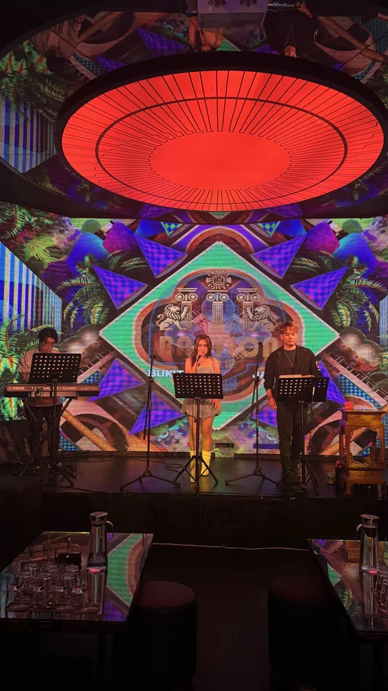 Circular red ceiling feature and colourful stage backdrop at Babylon Club